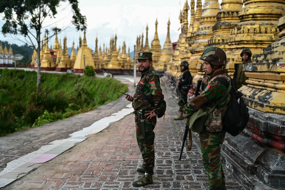 This photo taken on December 13, 2023 shows members of ethnic minority armed group Ta’ang National Liberation Army (TNLA) standing guard in a temple area of a hill camp seized from Myanmar’s military in Namhsan Township in Myanmar’s northern Shan State. — AFP pic