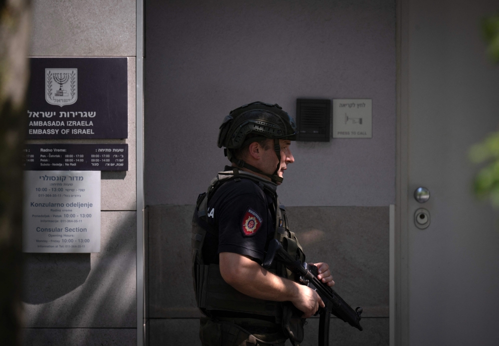 An armed Police officer is stationed in front of the  entrance to Israel's embassy in Belgrade, on June 29, 2024. — AFP pic