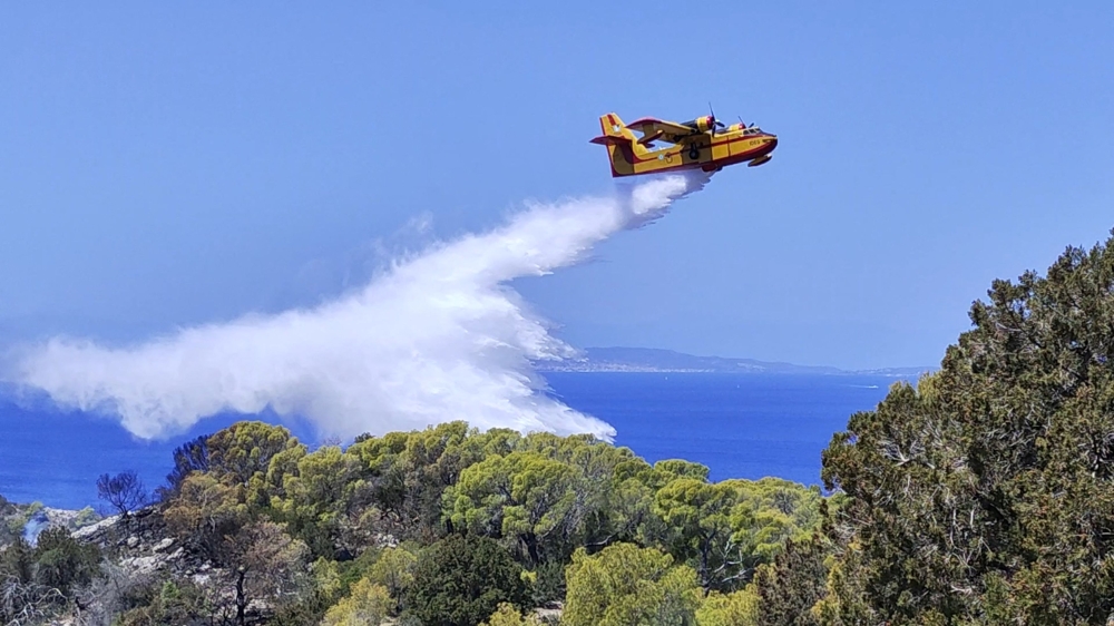 File photo of a firefighting plane dropping water over an area affected by a forest fire on the island of Hydra, Greece June 22, 2024 in this screen grab from social media video. — Reuters pic