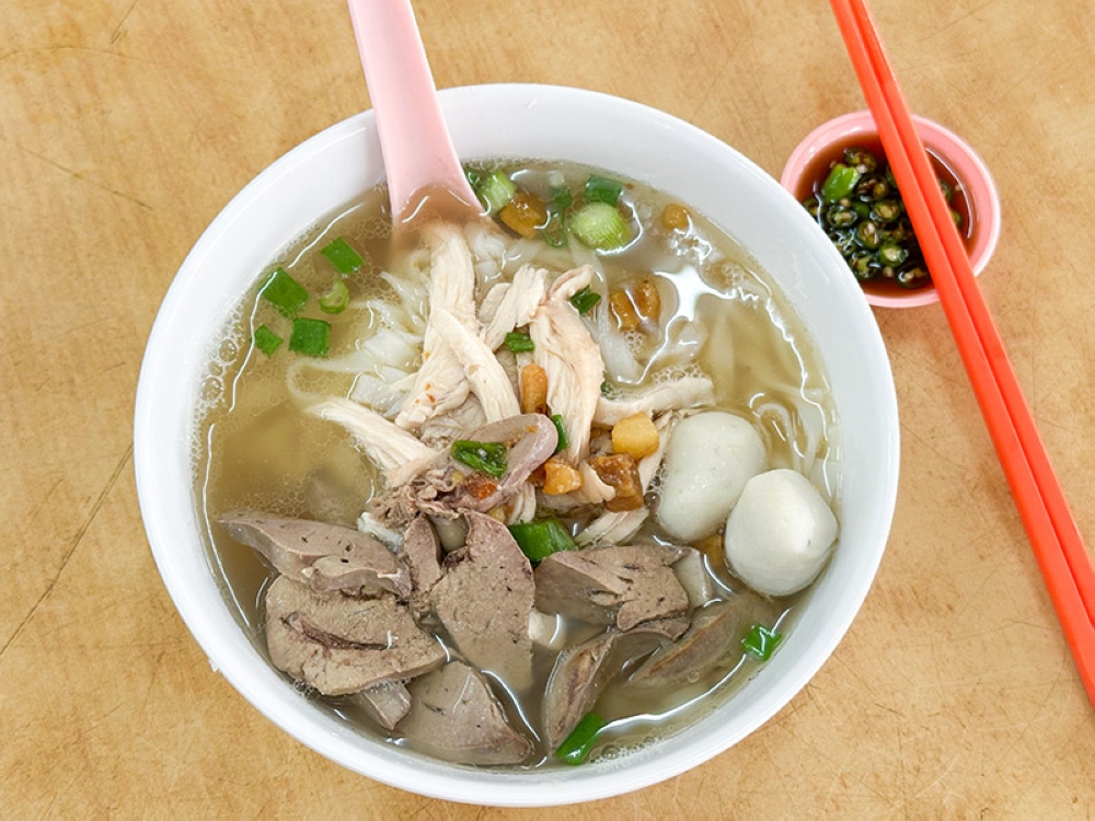 Nothing comforts more than a warm bowl of smooth 'kuey teow' like this one from Restoran Shoon Lee, garnished with shredded chicken, pork meat, fishballs, chicken liver and a dollop of lard crisps. — Pictures by Lee Khang Yi