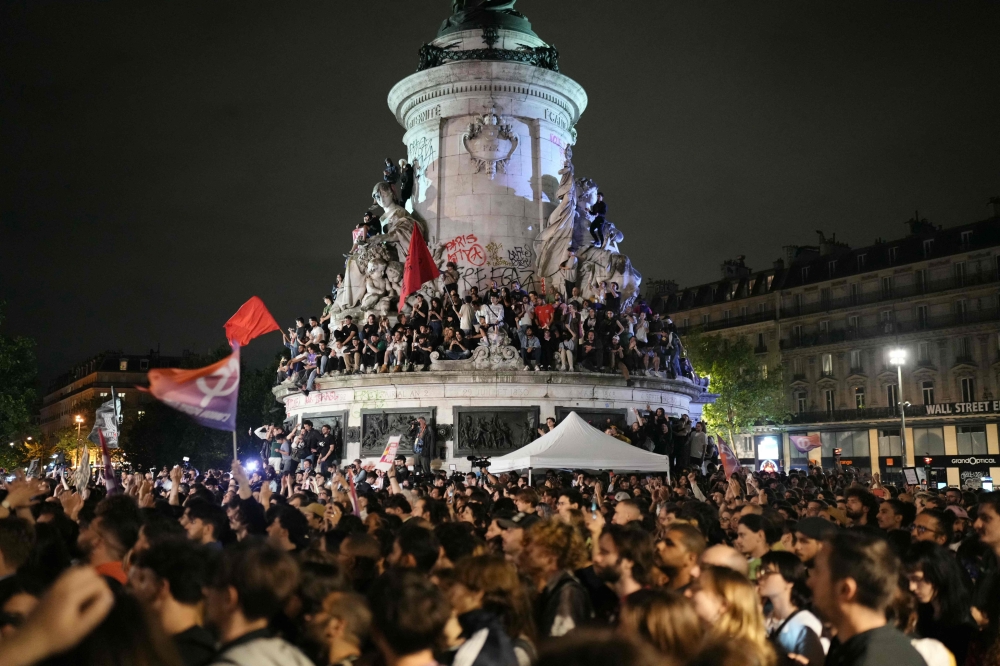 Demonstrators take part in a rally against far-right after the announcement of the results of the first round of parliamentary elections at Place de la Republique in Paris on June 30, 2024. — AFP pic