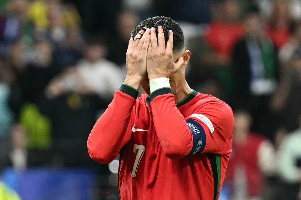 Portugal's forward #07 Cristiano Ronaldo reacts after failing to score a penalty kick during the UEFA Euro 2024 round of 16 football match between Portugal and Slovenia at the Frankfurt Arena in Frankfurt am Main on July 1, 2024. – AFP pic