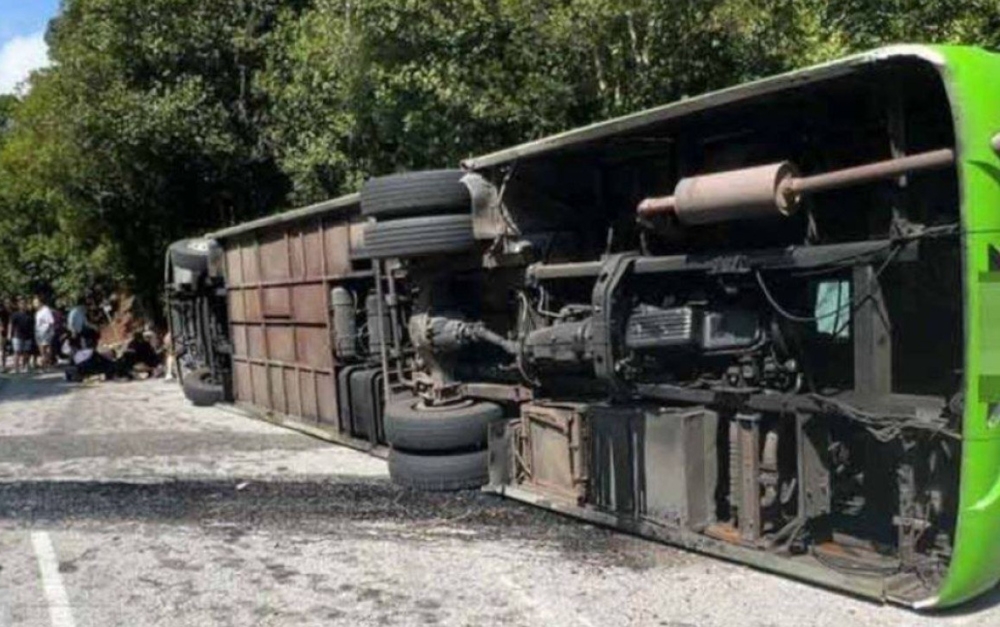 In the 11am incident, two male Chinese nationals were killed while 19 others were rescued after their tour bus was believed to have veered off, crashed into a road divider and overturned en route to the capital city. — Picture from social media 
