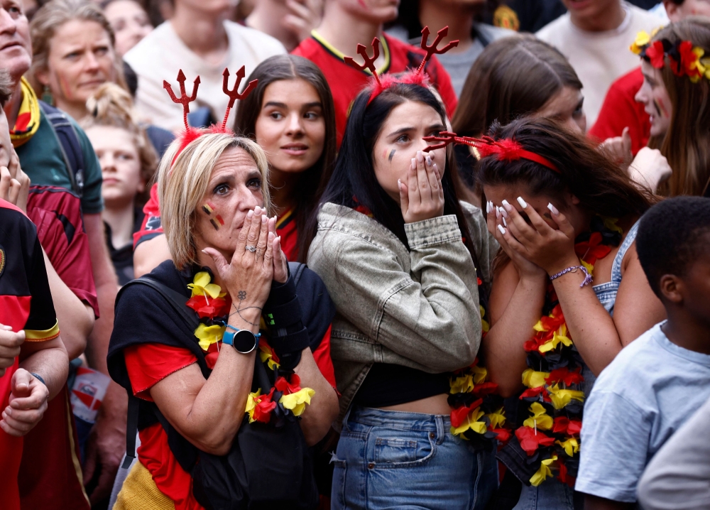 Fans gather to watch France v Belgium. Fans react as they watch the match at a fanzone in Brussels. — Reuters pic 