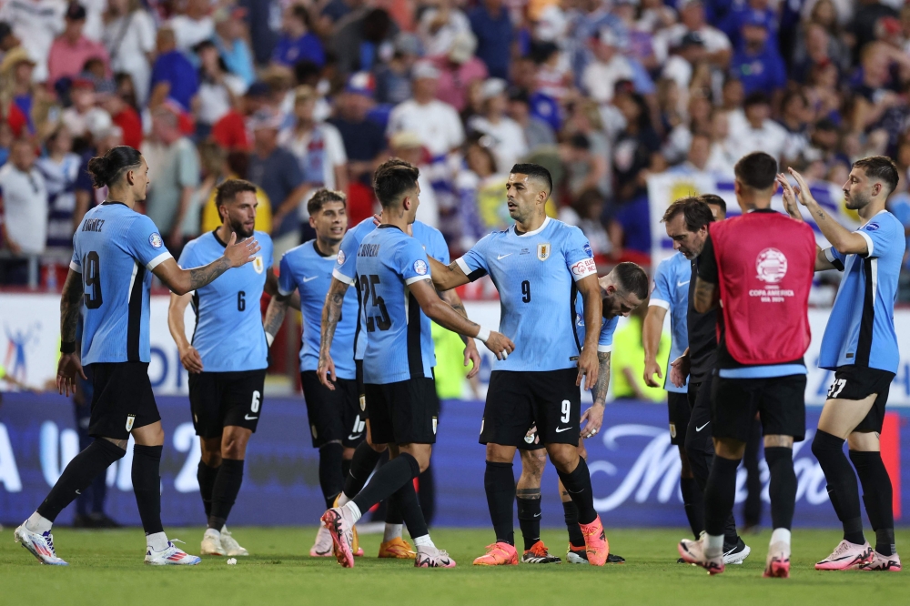 Luis Suarez of Uruguay and Cristian Olivera of Uruguay celebrate the team's victory and progression to the quarter finals after the CONMEBOL Copa America 2024 Group C match between United States and Uruguay at GEHA Field at Arrowhead Stadium. — AFP pic