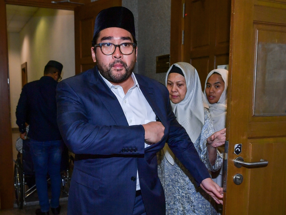 The widow of the late Tan Sri Jamaluddin Jarjis, Puan Sri Kalsom Ismail (centre) is pictured at the Kuala Lumpur Shariah Court on September 11, 2023. Also seen are her son and daughter Ikwan Hafiz (left) and Nur Anis Jamaludin Jarjis (right). — Bernama pic
