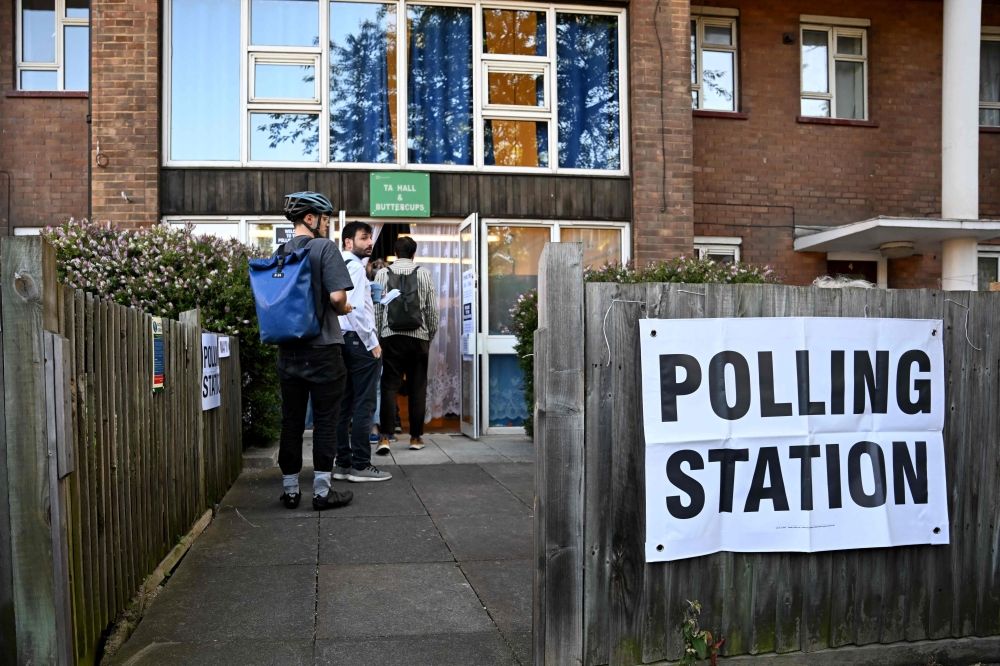 Britons voted today in a general election widely expected to emphatically return the opposition Labour party to power and end nearly a decade-and-a-half of Conservative rule. — AFP pic