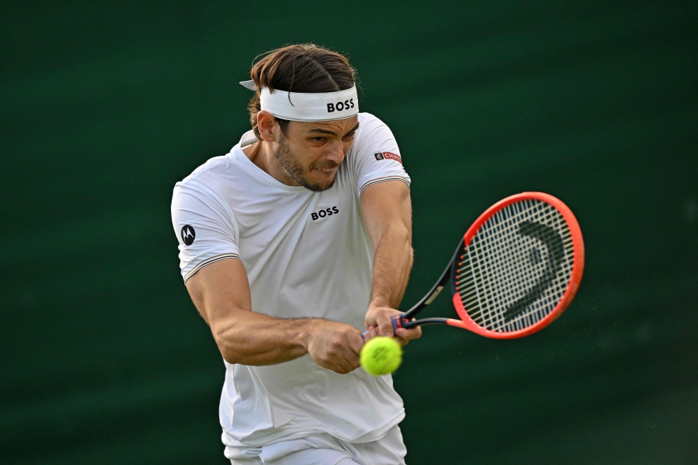 US player Taylor Fritz returns against France’s Arthur Rinderknech during their match on the fourth day of the 2024 Wimbledon Championships. — AFP pic