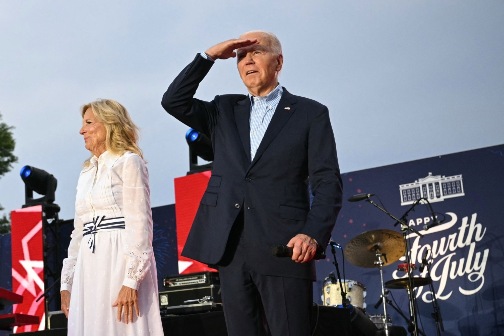 US President Joe Biden (R) stands with US First Lady Jill Biden onstage during a Fourth of July celebration for military and veteran families, caregivers, and survivors, on the South Lawn of the White House in Washington, DC, on July 4, 2024. — AFP pic