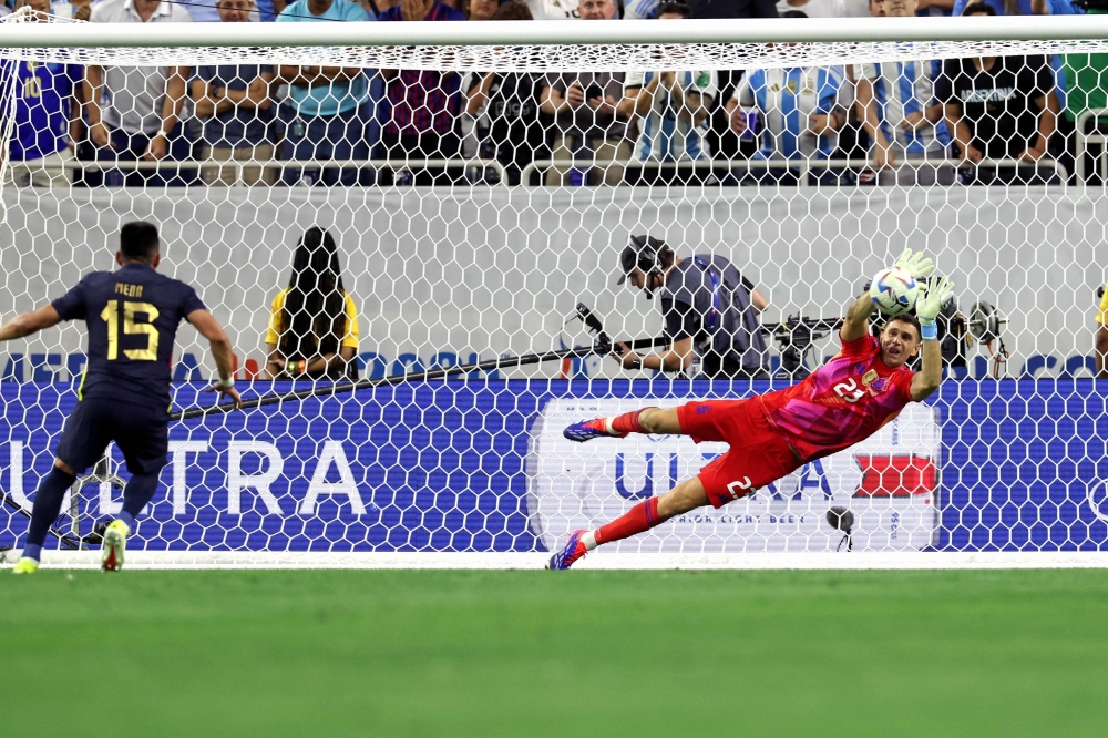 Goalkeeper Emiliano Martinez was the hero, saving two penalties and Lionel Messi’s blushes as holders Argentina defeated Ecuador in a penalty shoot-out to book their place in the Copa America semi-finals today. — AFP pic