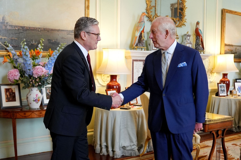 Britain’s King Charles III welcomes Britain’s incoming Prime Minister Keir Starmer during an audience at Buckingham Palace in London on July 5, 2024, a day after Britain held a general election. — AFP pic