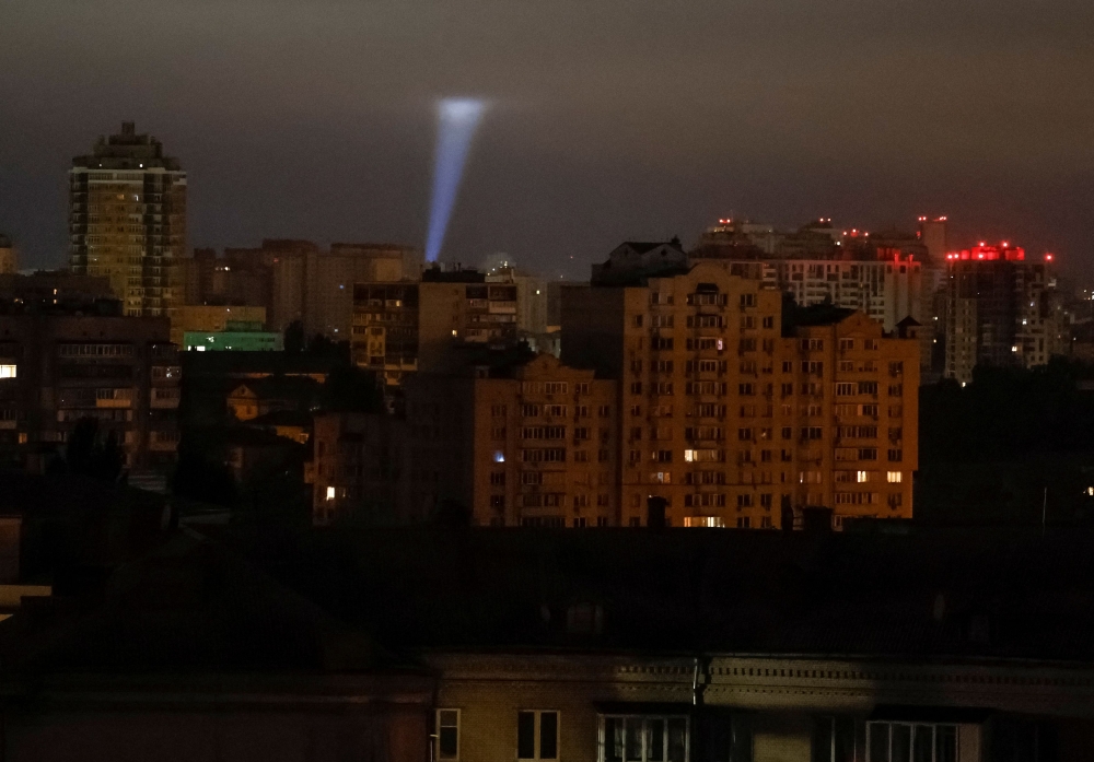 FIle image of  Ukrainian servicemen using a searchlight as they search for drones in the sky over the city during a Russian drone strike. — Reuters