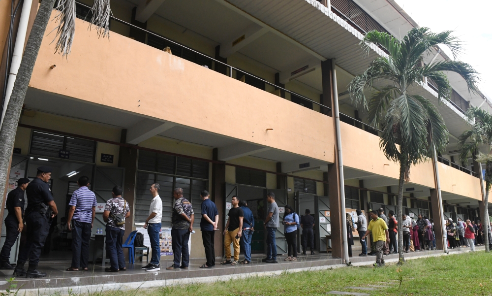 Voters stand in line to cast their votes for the Sungai Bakap state by-election a polling station July 6, 2024. — Bernama pic