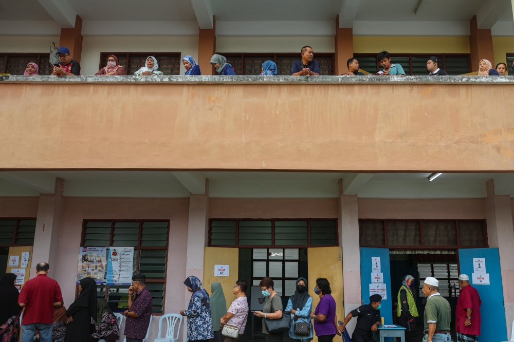 People wait in line to cast their ballot at a polling station in Nibong Tebal July 6, 2024 during voting for the Sungai Bakap state seat. — Bernama pic