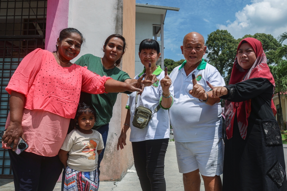 Resident of Kampung Wellesley, Cheoh Bak Choon, (4th from left), is pictured with fellow villagers after casting their votes in the Sungai Bakap state by-election at SK Sungai Duri in Nibong Tebal July 6, 2024. — Bernama pic