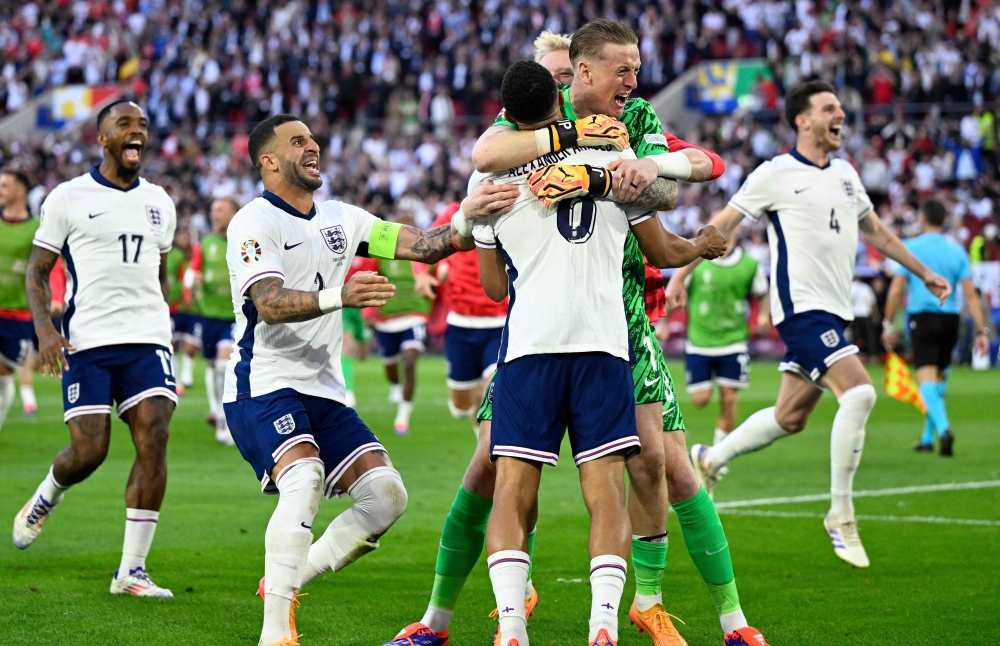 England’s forward #17 Ivan Toney, England’s defender #02 Kyle Walker, England’s defender #08 Trent Alexander-Arnold, England’s goalkeeper #01 Jordan Pickford and England’s midfielder #04 Declan Rice celebrate after winning the Uefa Euro 2024 quarter-final football match between England and Switzerland at the Duesseldorf Arena in Duesseldorf on July 6, 2024. — AFP pic