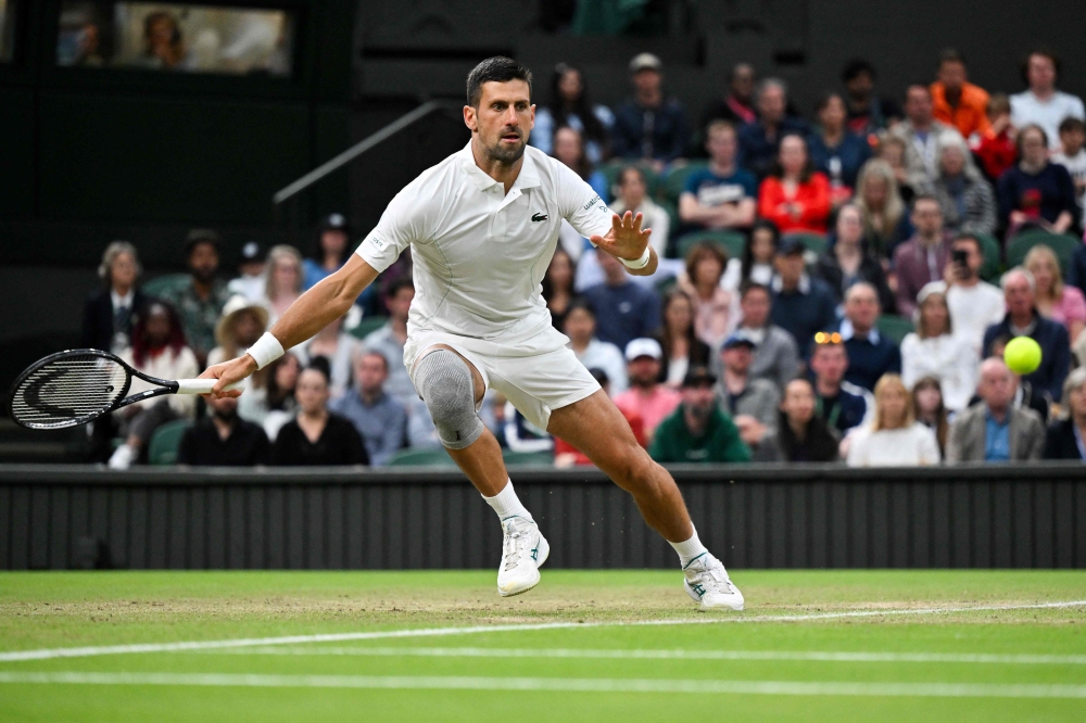 Serbia's Novak Djokovic returns the ball to Australia's Alexei Popyrin during their men's singles tennis match on the sixth day of the 2024 Wimbledon Championships at The All England Lawn Tennis and Croquet Club in Wimbledon July 6, 2024. — AFP pic
