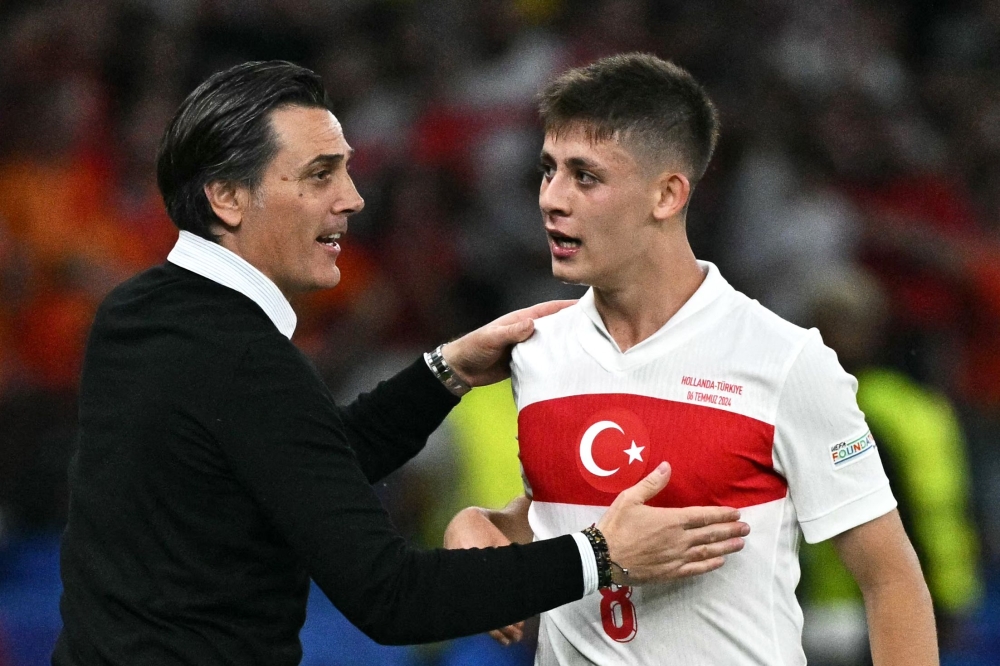 Turkiye’s Italian head coach Vincenzo Montella (left) celebrates with Turkiye’s forward #08 Arda Guler after their team scored the opening goal during the Uefa Euro 2024 quarter-final football match between the Netherlands and Turkiye at the Olympiastadion in Berlin on July 6, 2024. — AFP pic