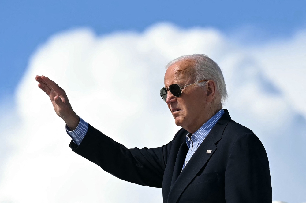 Biden waves as he boards Air Force One before departure from Dane County Regional Airport in Madison, Wisconsin on July 5. — AFP pic