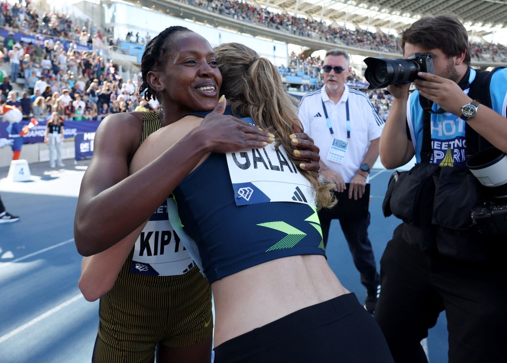 Kipyegon celebrates after winning the women's 1500m to set a new world record. — Reuters pic 