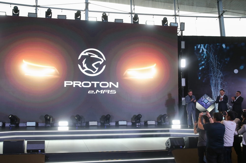 (From left) File picture of Proton chairman Datuk Seri Syed Faisal Albar, Proton chief executive officer Dr Li Churning and Proton deputy chief executive officer Roslan Abdullah during the launch of the new Proton EV Brand and logo at the Proton Centre of Excellence Centre in Subang Jaya, June 12, 2024. Proton teased that its first EV would debut by the end of the year, but did not share more beyond that it would be based on the new Global Modular Architecture (GMA) platform of its parent firm, Geely Holding of China. — Picture by Yusof Mat Isa