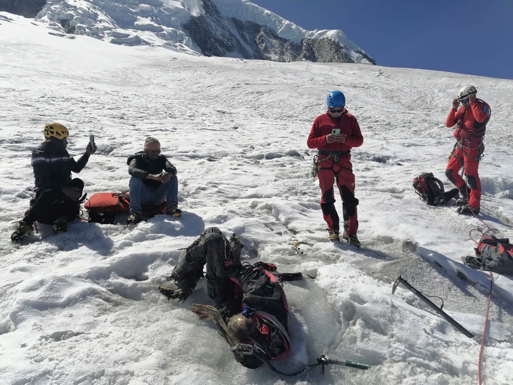Undated handout picture released by Peruvian National Police on July 8, 2024, showing police officers next to the body of US mountain climber William Stampfl, who was reported missing in June 2002, in the Ancash region, 400km north of Lima. — Peruvian National Police handout pic via AFP