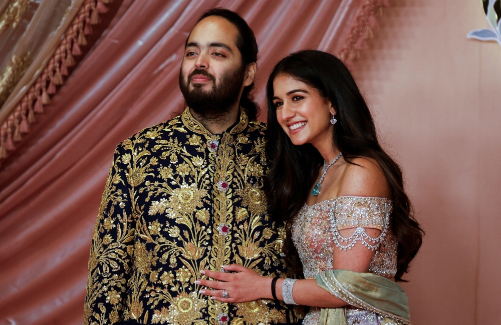 Anant Ambani, son of businessman Mukesh Ambani, poses with his fiance Radhika Merchant on the red carpet during the sangeet ceremony at Jio World Centre, Mumbai, India, July 5, 2024. — Reuters pic