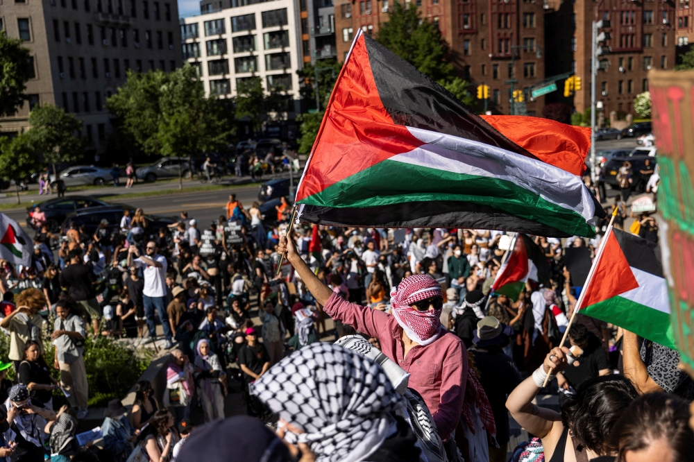 File picture of Pro-Palestinian protestors trying to enter the Brooklyn Museum in the Brooklyn borough of New York, May 31, 2024. The US intelligence chief on Tuesday accused Iran of egging on protests inside the United States against the Gaza war, including by paying demonstrators. — Reuters pic