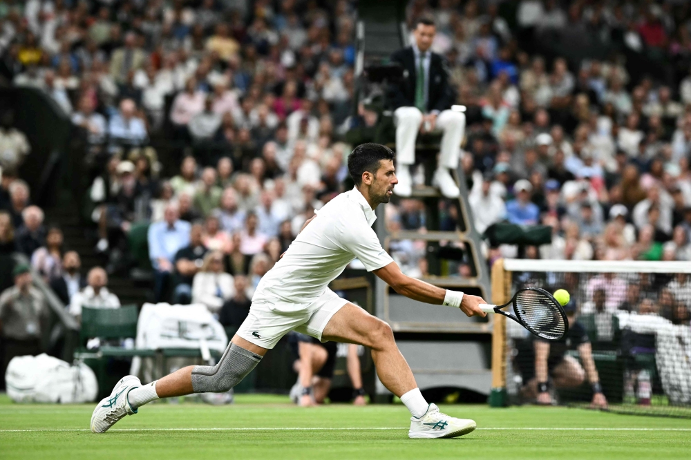 Serbia’s Novak Djokovic returns the ball to Denmark’s Holger Rune during their men’s singles tennis match on the eighth day of the 2024 Wimbledon Championships at The All England Lawn Tennis and Croquet Club in Wimbledon, southwest London, on July 8, 2024. — AFP pic 