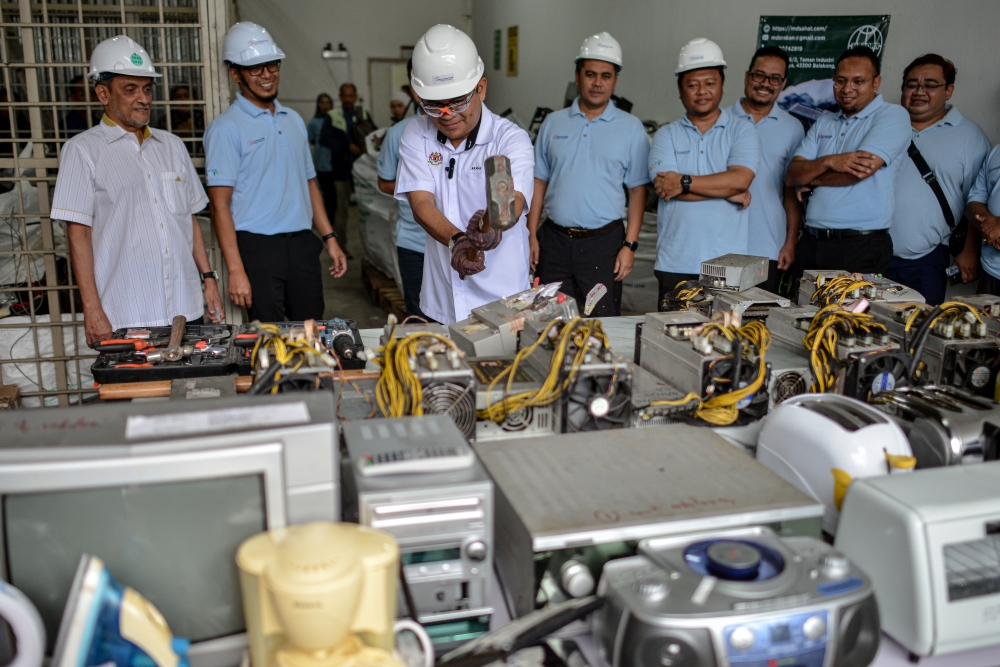 Deputy Energy Transition and Water Transformation Minister Akmal Nasrullah Mohd Nasir destroys RM2 million worth of seized electronic goods, including bitcoin mining machines seized in an operation in October 2022. July 10, 2024. — Bernama pic