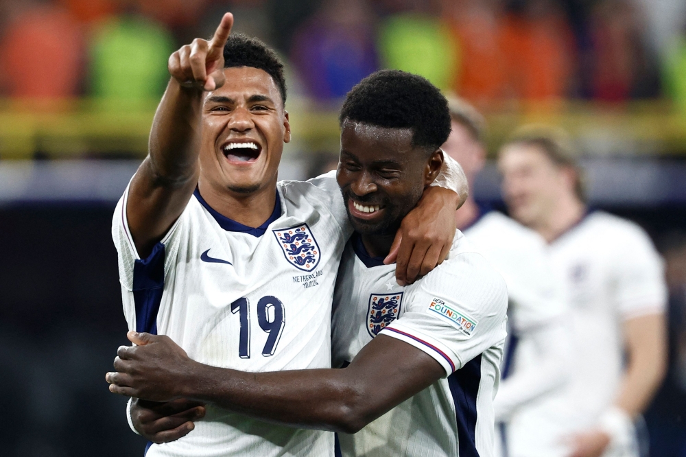 TOPSHOT - England's forward #19 Ollie Watkins (L) and England's defender #06 Marc Guehi celebrate after winning the UEFA Euro 2024 semi-final football match between the Netherlands and England at the BVB Stadion in Dortmund on July 10, 2024. — AFP pic