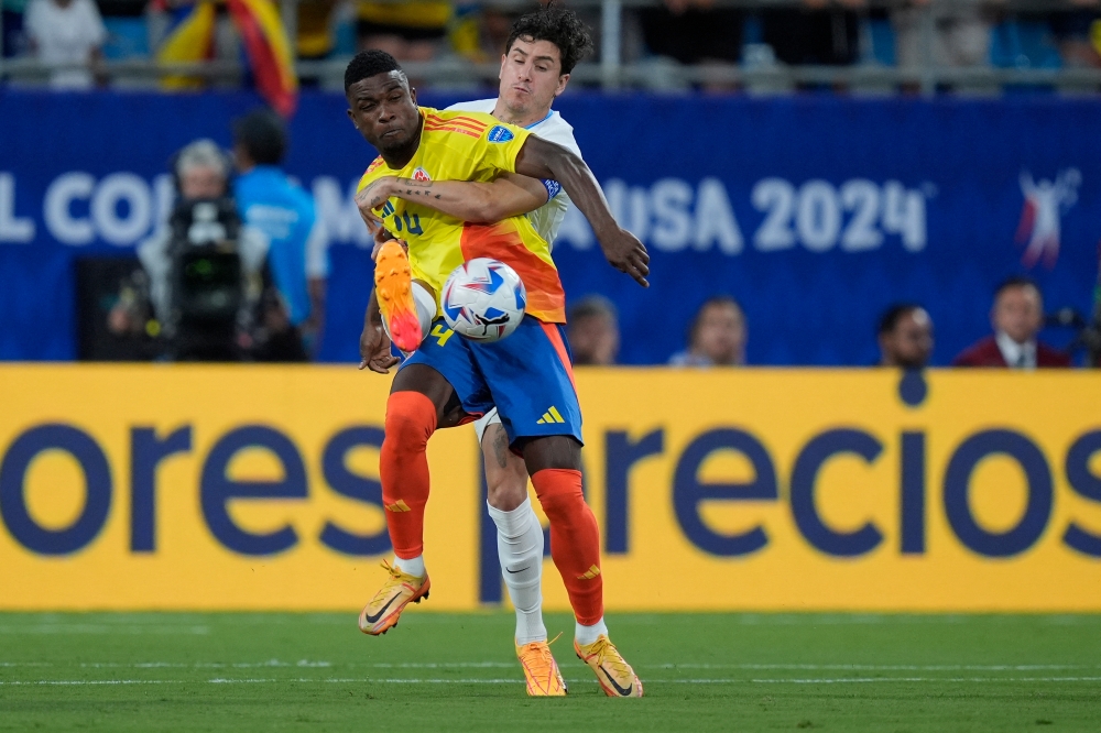 Columbia defender Angela Baron (14) and Uruguay defender Jose Gimenez (2) fight for the ball during the first half at the Copa Armerica semifinal match at Bank of America Stadium. — USA TODAY/Jim Dedmon via Reuters pic