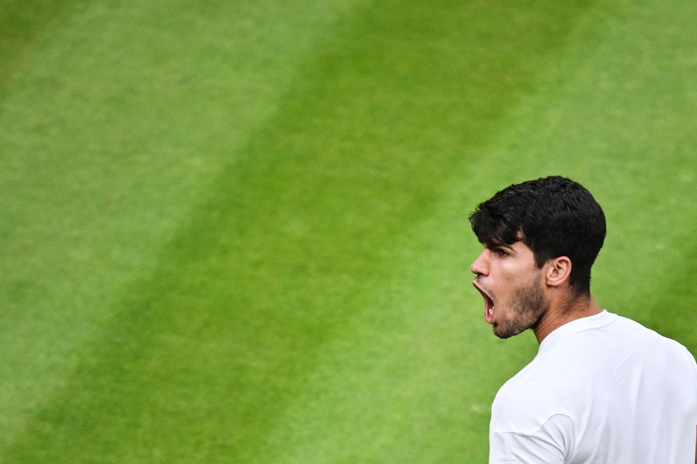 Spain’s Carlos Alcaraz celebrates winning against USA’s Tommy Paul during their men’s singles quarter-finals tennis match on the ninth day of the 2024 Wimbledon Championships at The All England Lawn Tennis and Croquet Club in Wimbledon, on July 9, 2024. — AFP pic 