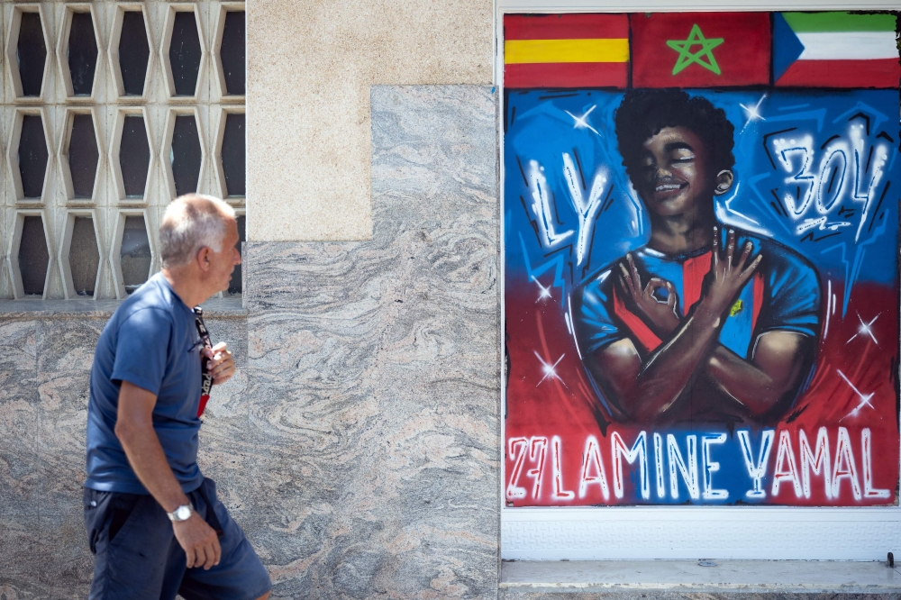 A man walks past a graffiti depicting Lamine Yamal in Rocafonda, the neighbourhood where Spain’s forward grew up, in Mataro, 35km from Barcelona, on July 11, 2024. — AFP pic 