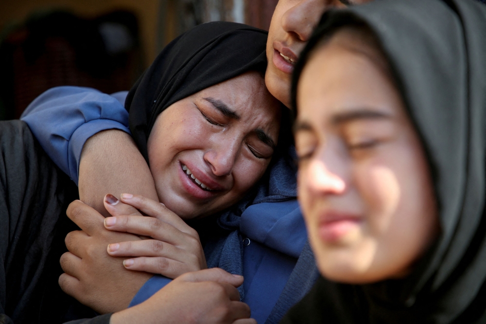 Relatives of a Palestinian killed in an Israeli strike react at the site of the strike, near a school sheltering displaced people, amid the Israel-Hamas conflict, in Khan Younis in the southern Gaza Strip July 10, 2024. — Reuters pic 