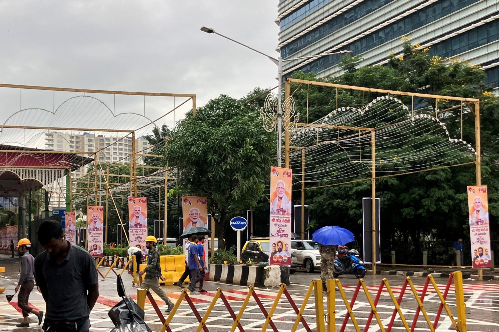 People walk past posters of India’s Prime Minister Narendra Modi outside Jio World Convention Centre, the wedding venue of Anant Ambani, son of Indian billionaire Mukesh Ambani, in Mumbai, India, July 12, 2024. — Reuters pic 