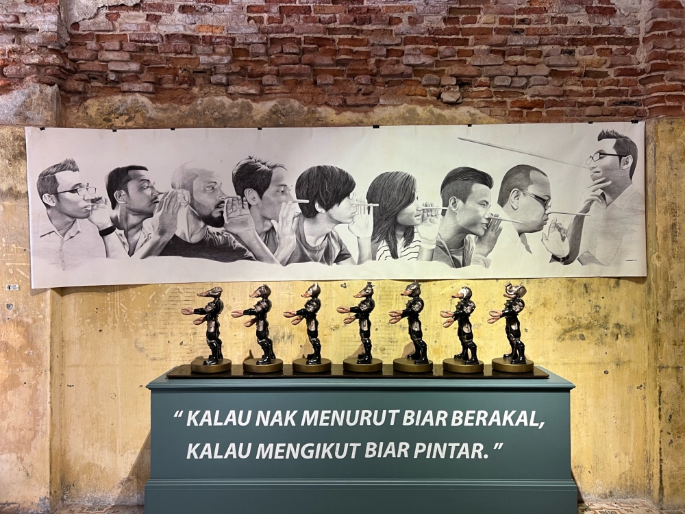 ‘Khabar Angin’ by Syahbandi Samat (background) and ‘Follow the Leader’ by Mohd Al-Khuzairie Ali. — Picture by Opalyn Mok