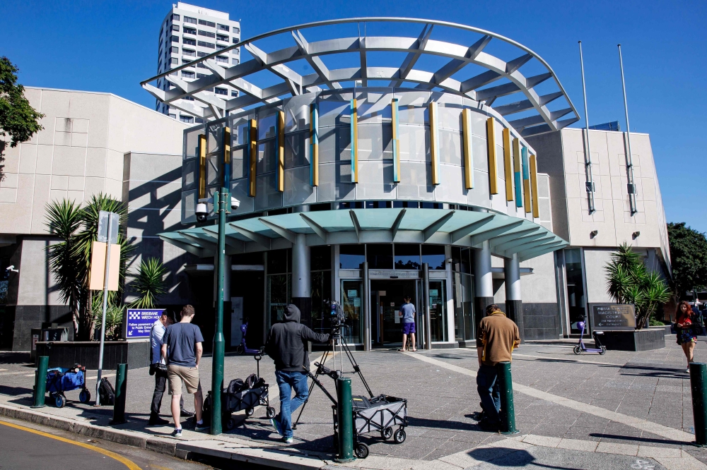 Members of the media stand outside the Brisbane Watch House in Brisane on July 12, 2024, where a 40-year-old woman and her 62-year-old husband — both holders of Russian passports — appeared before a magistrate after being charged with ‘preparing for an espionage offence’. — AFP pic