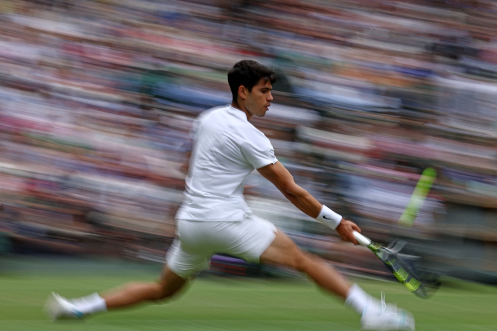 Spain’s Carlos Alcaraz returns against Russia’s Daniil Medvedev during their men’s singles semi-final tennis match on the twelfth day of the 2024 Wimbledon Championships at The All England Lawn Tennis and Croquet Club in Wimbledon July 12, 2024. — AFP pic