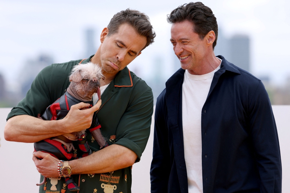 Hugh Jackman and Ryan Reynolds with Britain’s ugliest dog Peggy, who plays Dogpool in ‘Deadpool & Wolverine’. — Reuters pic