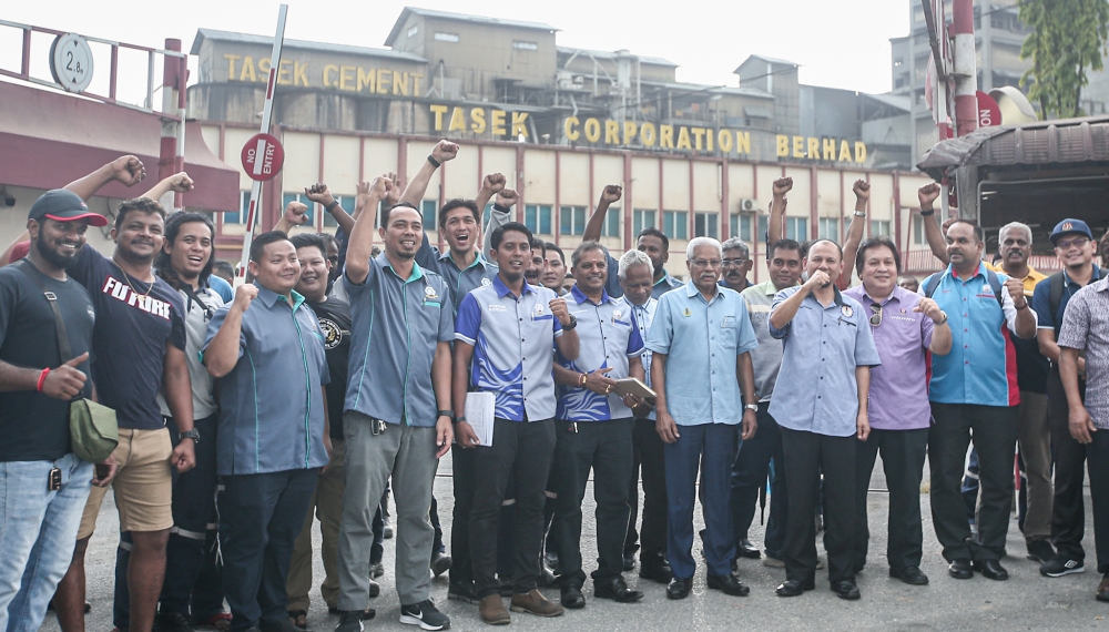 Workers at a cement plant in Ipoh pose with Perak Human Resources exco A. Sivanesan (sixth from right) during a visit on April 22 April, 2024. — Picture by Farhan Najib
