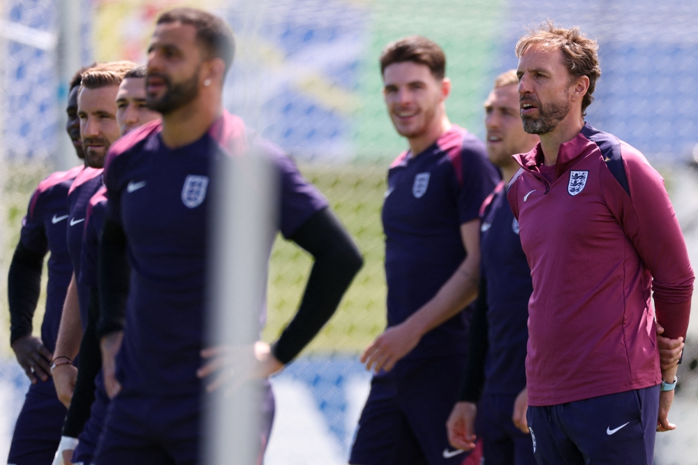 England’s head coach Gareth Southgate and his players at a training session earlier today. — AFP pic