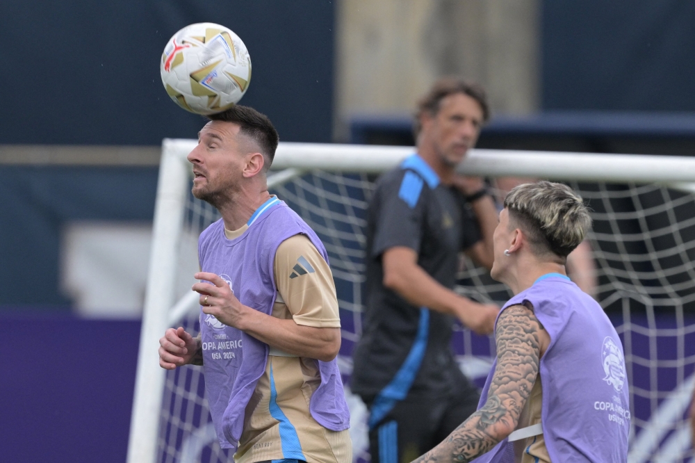 Argentina’s forward Lionel Messi heads the ball forward Alejandro Garnacho during a training session one day before the Conmebol 2024 Copa America tournament final football match between Argentina and Colombia at the Florida International University (FIU) in Miami, Florida, July 13, 2024. — AFP pic 