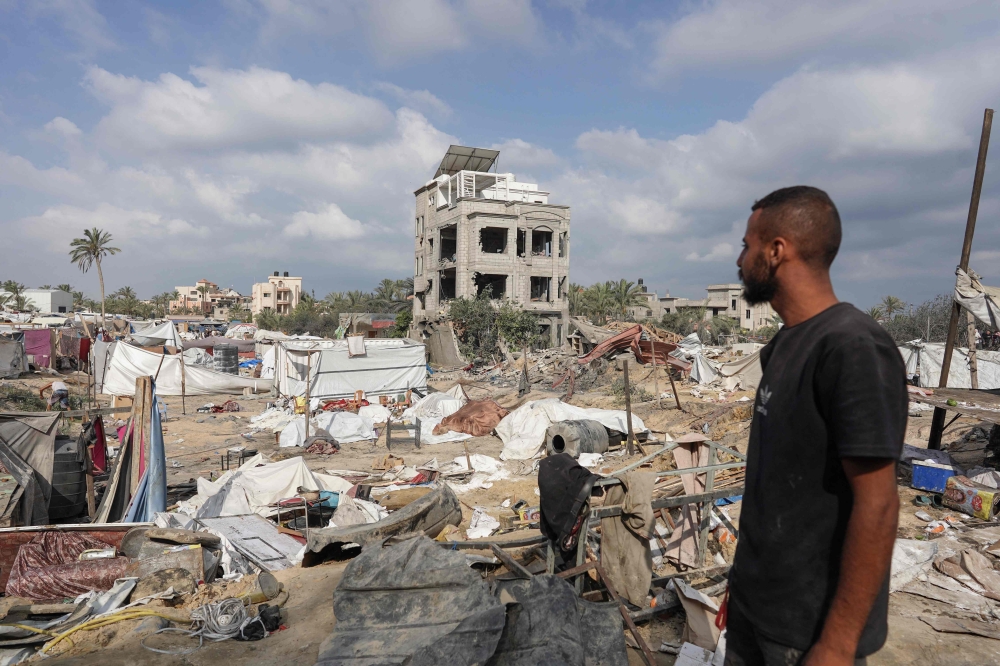 A Palestinian man looks at damaged tents at the site of Israeli bombardment a day earlier on the al-Mawasi displacement camp of Khan Yunis city in the southern Gaza Strip on July 14, 2024, amid the ongoing conflict between Israel and the Palestinian militant Hamas group in Gaza. — AFP pic