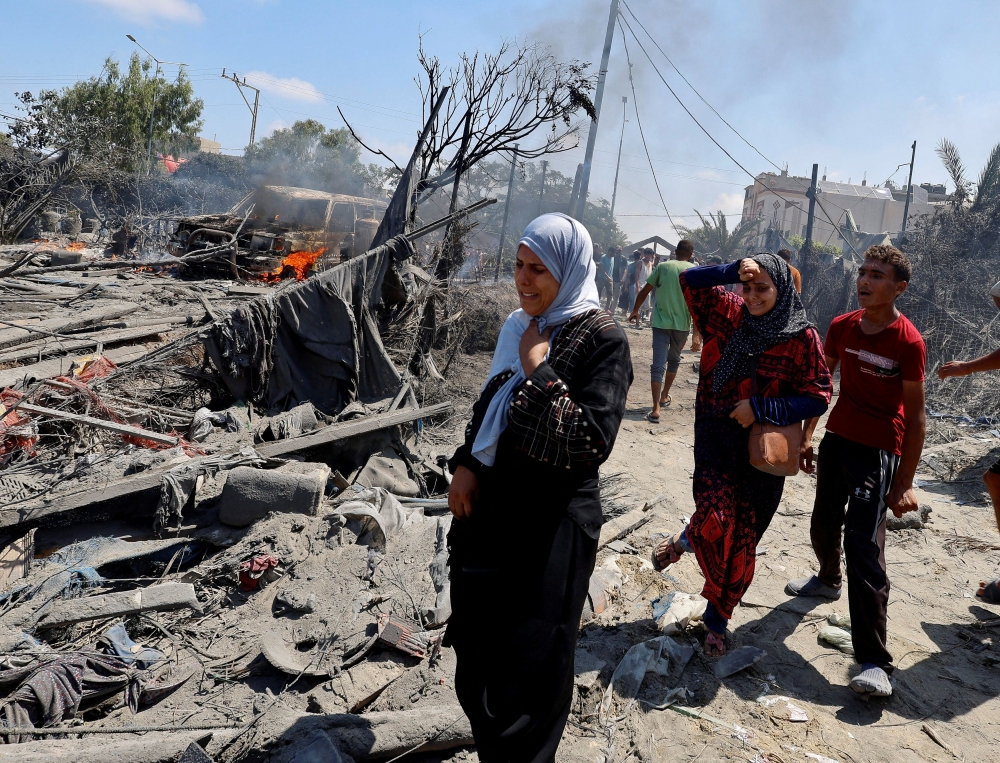Palestinians react near damage, following what Palestinians say was an Israeli strike at a tent camp in Al-Mawasi area, amid Israel-Hamas conflict, in Khan Younis in the southern Gaza Strip July 13, 2024. — Reuters pic