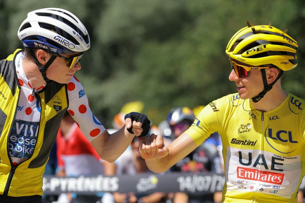 UAE Team Emirates team’s Slovenian rider Tadej Pogacar wearing the overall leader’s yellow jersey fist bumps Team Visma-Lease a Bike team’s Danish rider Jonas Vingegaard wearing the climber’s polka dot (dotted) jersey. — AFP pic