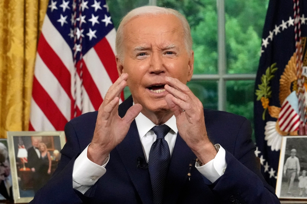 US President Joe Biden addresses the nation from the Oval Office of the White House in Washington, Sunday, July 14, 2024, a day after his political rival Donald Trump was shot at in Pennsylvania. — AFP pic