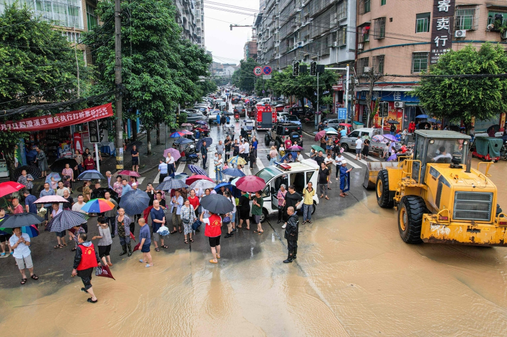 Chinese authorities evacuating Dianjing residents in southwestern Chongqing after heavy rains flooded the area on July 11, 2024. — AFP pic