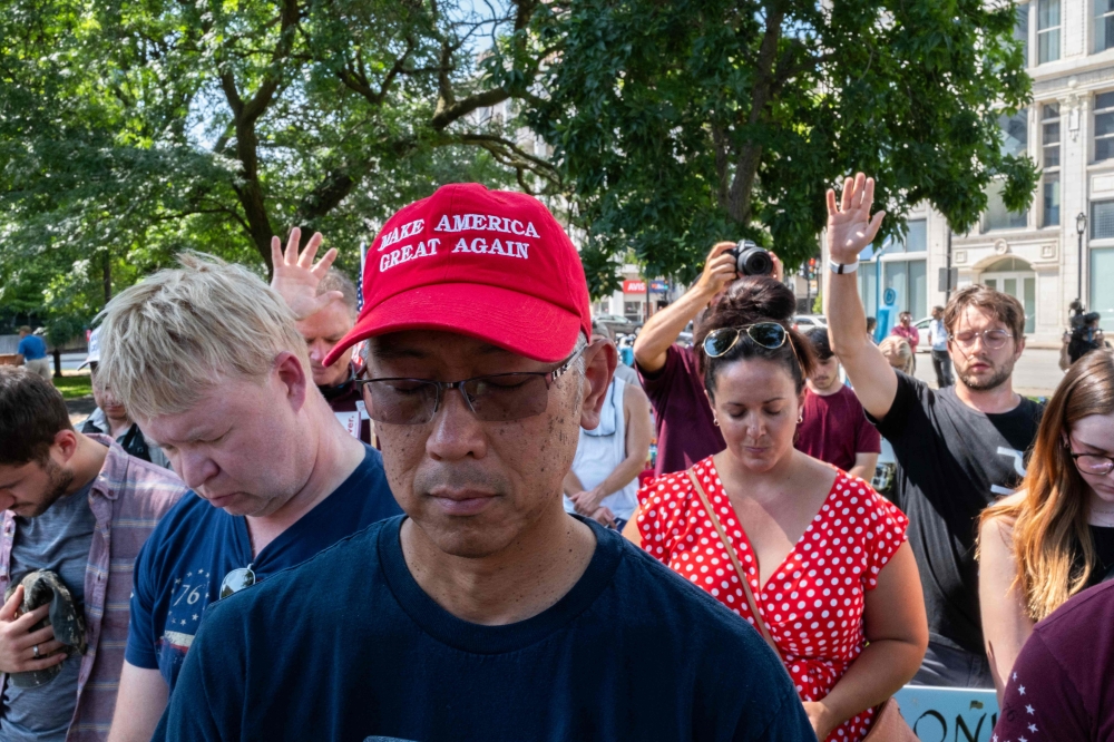 A group of Trump supporters pray for former President Donald Trump in Milwaukee, Wisconsin during a prayer vigil on July 14, 2024. — AFP pic