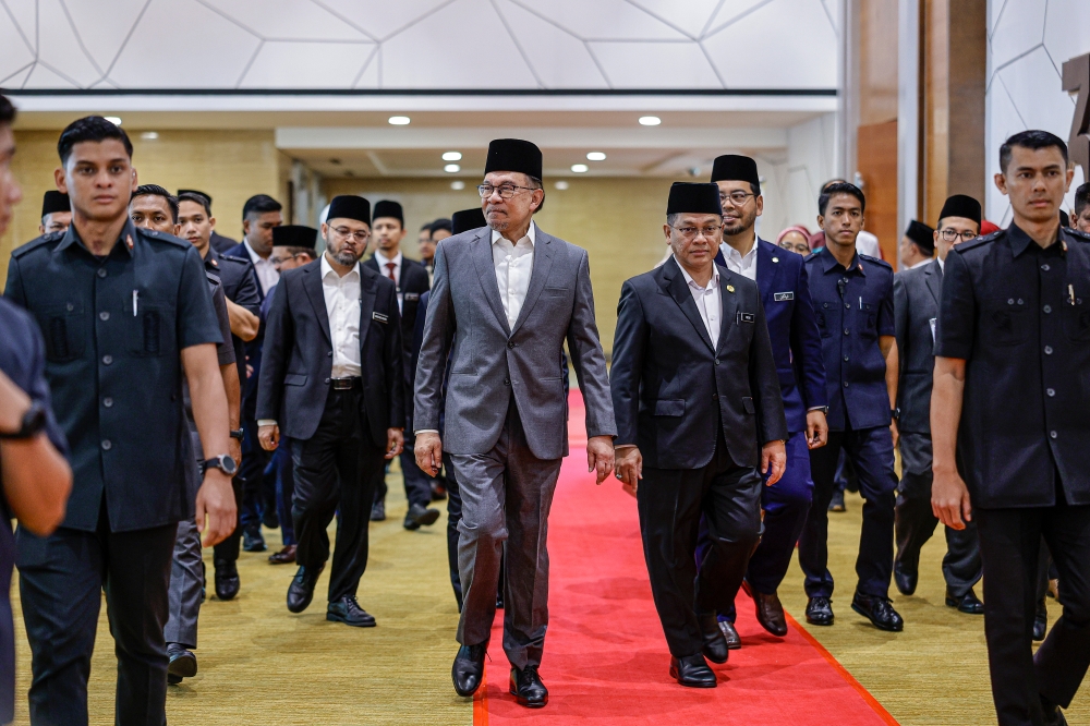 Prime Minister Datuk Seri Anwar Ibrahim at the Convention to Dignify Malaysia’s Syariah Law and Judiciary in Putrajaya, July 15, 2024. With him is Minister in the Prime Minister’s Department (Religious Affairs), Datuk Mohd Na’im Mokhtar. — Bernama pic 